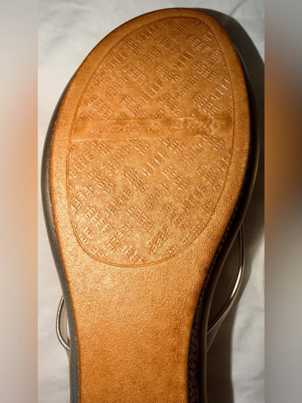 Italian Shoemakers thong wedge sandals feature a metallic gold finish